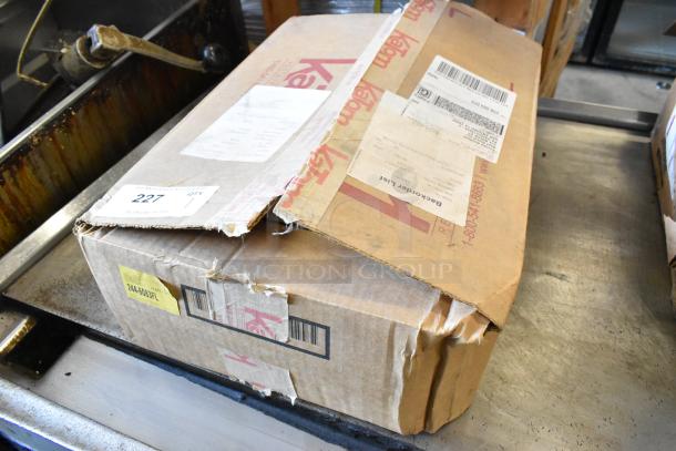 Box of Winware WHW-10 Glove Box Holder, new in slightly damaged packaging with visible shipping labels.
