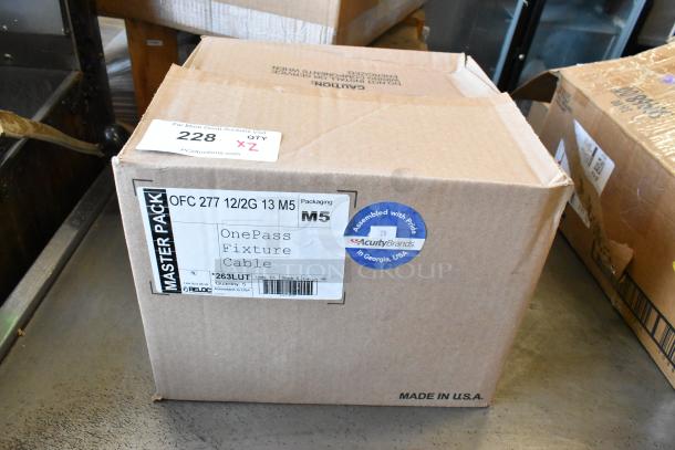 New Reloc OFC 277 12/2G 13 M5 OnePass Fixture Cable in box. Box labeled "Master Pack," "Made in USA," and "AcuityBrands."