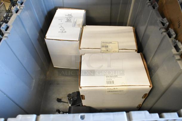 Three brand new Avigilon 2.0C-H5A-D1-IR cameras in unopened boxes, visible labels indicating model and condition.