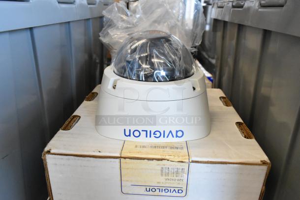 Brand new Avigilon 2.0C-H5A-D1-IR camera, dome style, on original packaging, showing model and serial numbers.