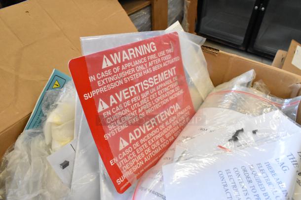 Lot of brand new items including Tripp Lite unit and Mobile Mark wires. Visible packaging with warning labels in various languages.