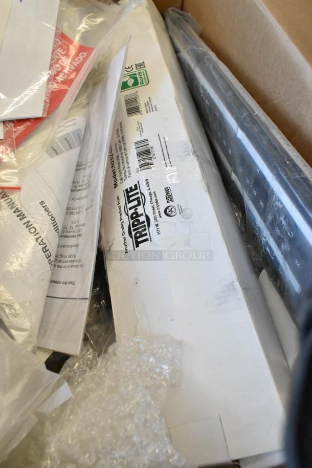 Lot of various brand new items, including a Tripp Lite unit in packaging and Mobile Mark wires, with visible labels and tags.