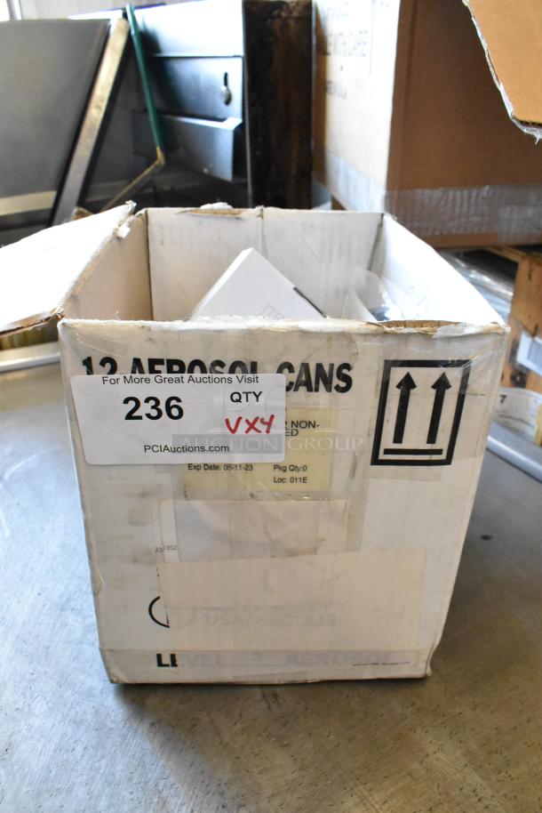 Box containing a lot of 4 brand new items, including a gas detector and wires. Box labeled "12 Aerosol Cans." Tag reads "236, VXY4."