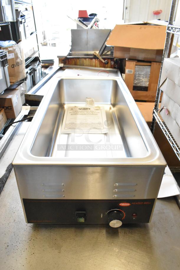 Brand new Hatco HW-43 stainless steel food warmer, 120V, 1 phase, with user manual. Includes control knobs and indicator light.