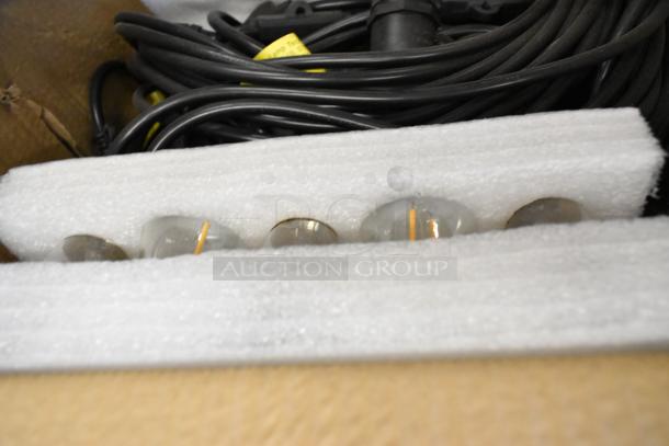 Brand new set of lights in box with protective foam packaging, visible bulbs, and coiled black cables.