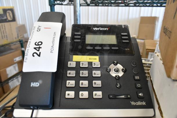 Verizon corded office telephone, Yealink T41S model, black with numeric keypad, display screen, and function buttons. Appears in good condition. Auction tag visible.