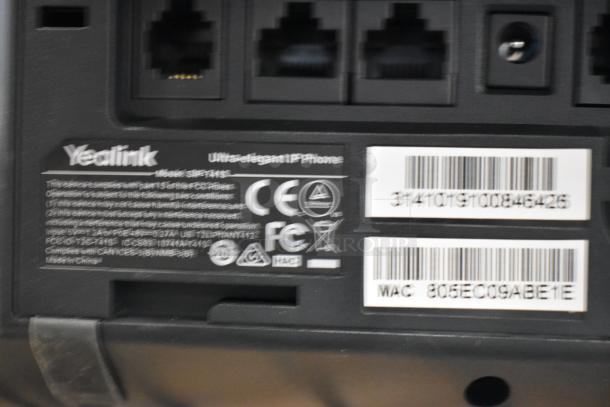 Close-up of the back of a Verizon corded office telephone, showing ports and labels. Yealink model SIP-T41S, "Ultra-elegant IP Phone."