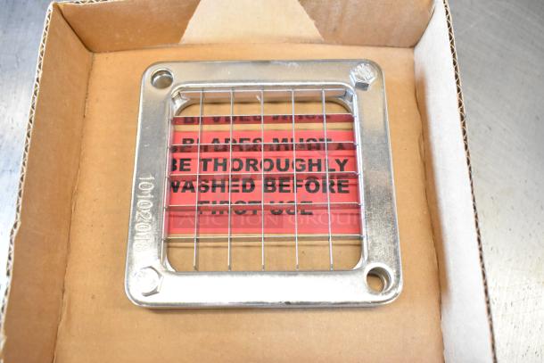 Brand new 55424-3 vegetable pusher blade in box, with stainless steel grid and warning label to wash before use.