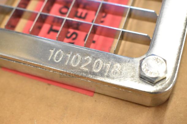 Close-up of new vegetable pusher blade model 55424-3 with engraved marking "10102018", shiny metal finish.