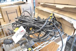 Coiled wire on a metal shelf, black with yellow tags, includes plug connectors. Label indicates item number 249.
