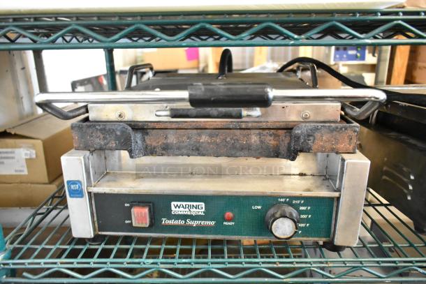 Waring WFG257 stainless steel commercial countertop panini press, 120 volts, worn condition with visible rust on top, NSF certified.