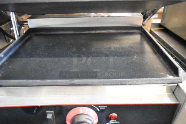 Winco ESG-1 stainless steel commercial countertop panini press, 120V, 1 phase, clean griddle, temperature dial visible.