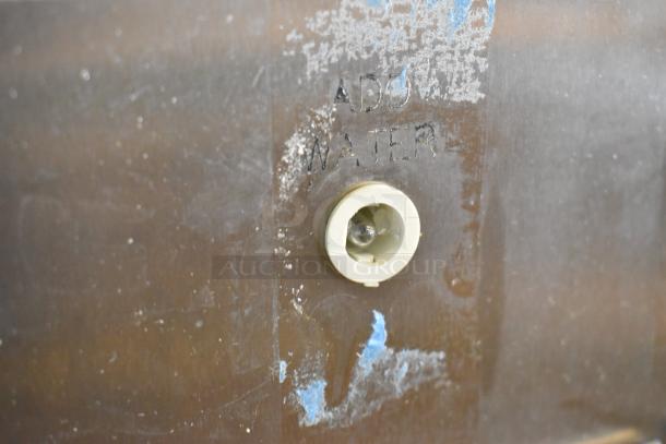 Antunes stainless steel countertop steamer detail, with "ADD WATER" marking beside a water level indicator.