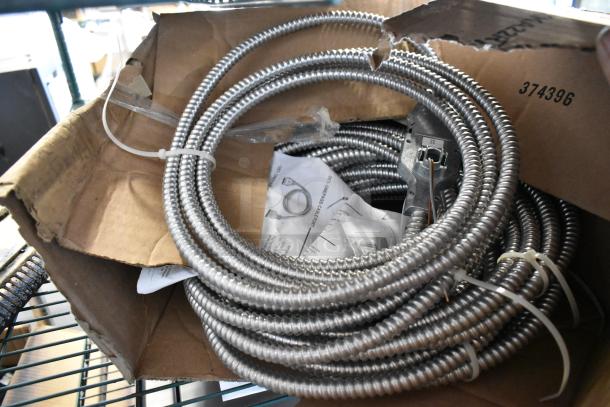 Brand new Reloc OFC 277 12/2G 13 M5 OnePass fixture cable in original box, loops of silver metallic conduit visible.