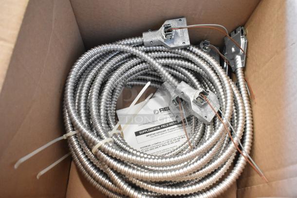 Brand new Reloc cable in box, features metal conduit, installation tags, and instruction manual visible.