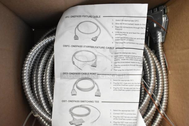 Brand new Reloc cable in box with installation guide. Coiled metal casing, new condition, labeled one-pass fixture cable.