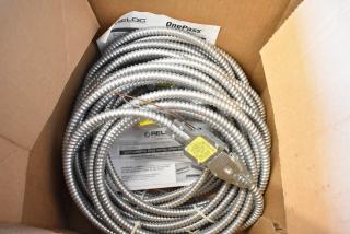 Brand new Reloc Cable in box, coiled metal design, attached labels with installation instructions, indicating unused condition.