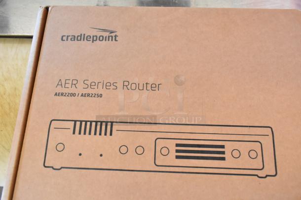 Brand new Cradlepoint AER Series Router in box, models AER2200/AER2250, unopened packaging, mint condition.