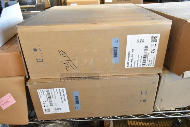 Two brand new NVR502A-16/16P-4KS2E Network Video Recorders in sealed boxes with labels.