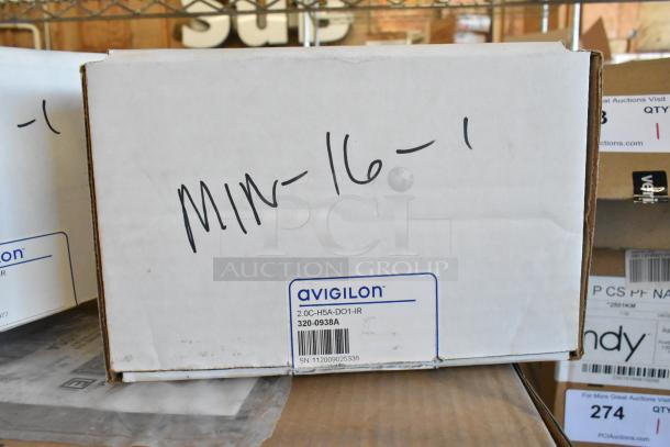 Box containing brand new Avigilon camera, model 2.0C-H5A-DO1-IR, with label and serial number visible.