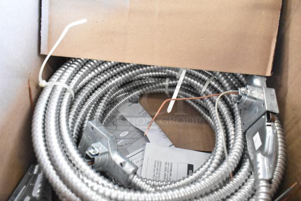 Brand new Reloc OFC 277 12/2G 13 M5 OnePass fixture cable in box, coiled with connectors, metal exterior.