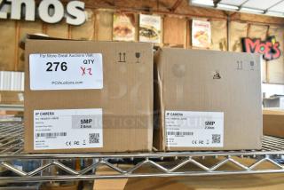 2 brand new HNC5I251R1-ASPV/28 IP cameras in boxes; 5MP, 2.8mm lens, auction quantity x2, packaging details visible.