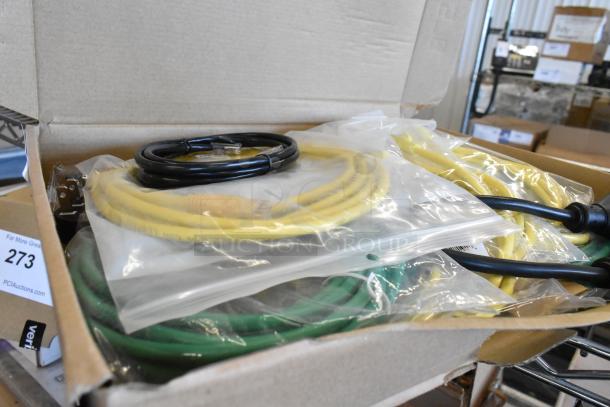Lot of various wires including yellow, green, and black cables in clear plastic bags inside a cardboard box.