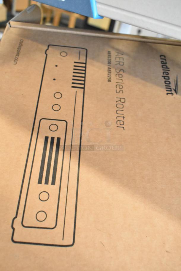 Cradlepoint AER Series Router box, new condition, featuring model AER2200/AER2250 graphic and branding on cardboard packaging.