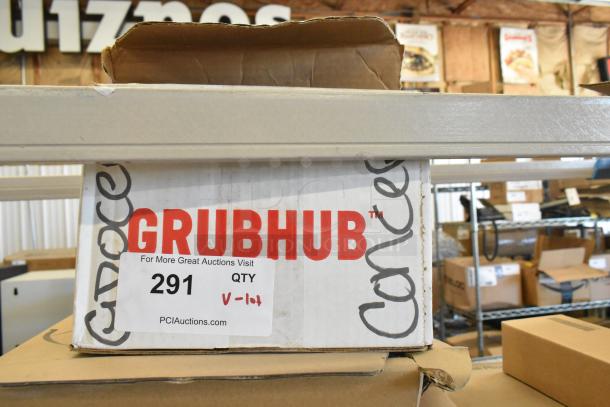 Cardboard box labeled "Grubhub" containing auction lot with a tablet and MiFi. Auction label showing lot number 291.