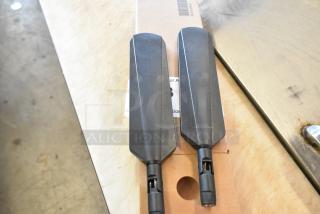 Two brand new antennas in black, packaged in a box.