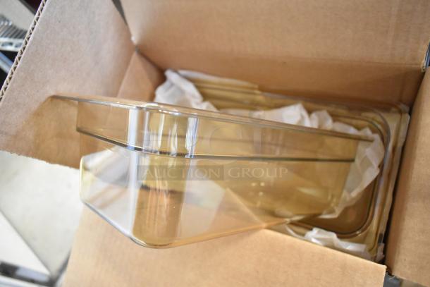 Box of 6 Carlisle 3086113 amber 1/3 size drop-in bins, brand new in open cardboard box, showcasing transparent design.