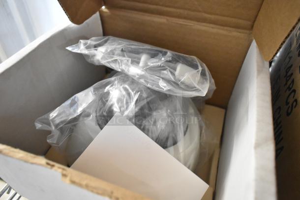 Brand new Avigilon camera in original packaging, four units included. Wrapped in plastic, indicative of new condition.