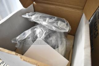 Brand new Avigilon camera in original packaging, four units included. Wrapped in plastic, indicative of new condition.