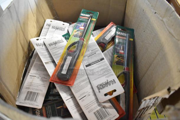 Box containing 21 brand new Handi flame lighters in original packaging, various colors, with visible safety instructions.