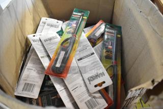 Box containing 21 brand new Handi flame lighters in original packaging, various colors, with visible safety instructions.