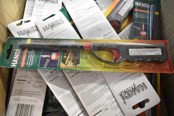 Handi Flame refillable lighter, brand new in packaging. Ideal for barbecues and camping with safety cautions visible.