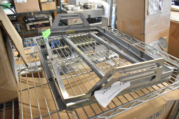 Brand new metal tray frame, still in box. Durable construction with modern design. Includes label indicating auction details.