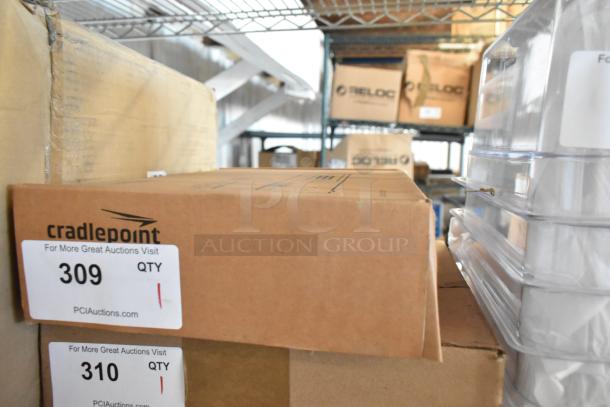 Brand new Cradlepoint Router in box, labeled with item number 309 and PCI Auctions details.