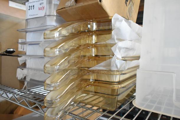 14 brand new poly drop-in bins, stacked on a metal shelf. Includes auction label "311" indicating quantity of 14.