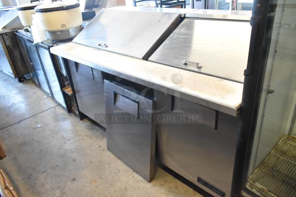 True TSSU-72-30M-S stainless steel sandwich prep table, mega top, on commercial casters. 115V, 1 phase. Good condition.