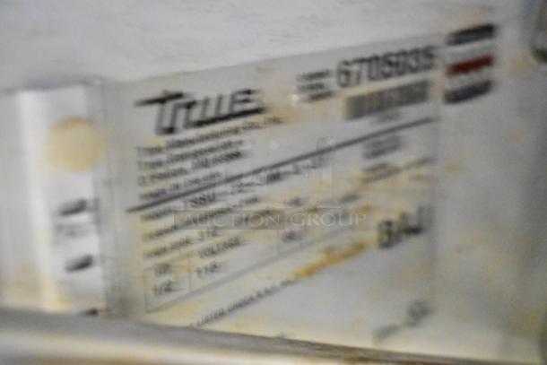 Blurred label of True TSSU-72-30M-S prep table, details partially visible. 115 Volts, 1 Phase.