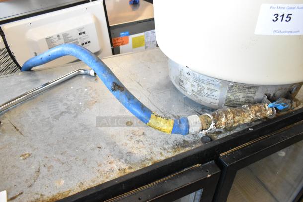 Rinnai RER-55AS-N countertop natural gas rice cooker with a blue hose attachment, showing signs of use. NSF label visible.