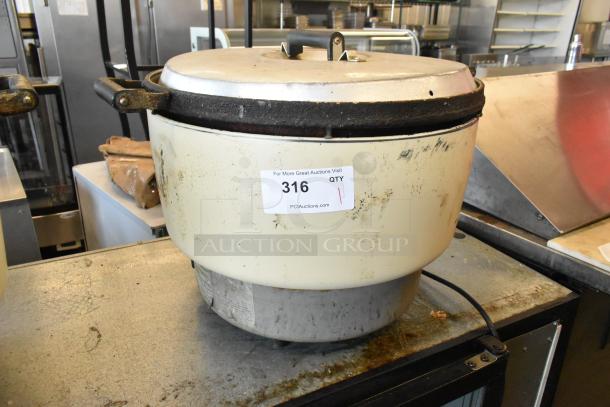 Rinnai RER-55AS-N countertop natural gas rice cooker with visible wear, auction tag, and power cord attached.