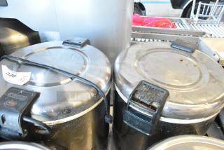 Two Thunder Group metal rice warmers, 120 volts, 1 phase, showing signs of use. Auction tag indicates quantity of two.