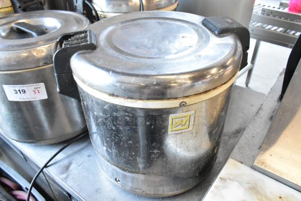 Two Thunder Group metal rice warmers, 120 volts, 1 phase. Visible wear. Auction tag 319, quantity 2.