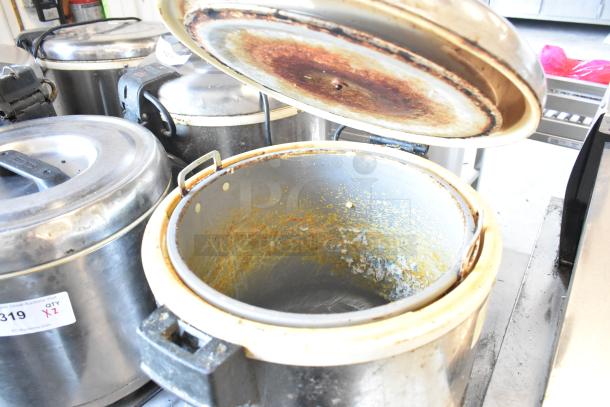 Two Thunder Group metal rice warmers, 120 volts, 1 phase, showing interior condition with some rust and residue.