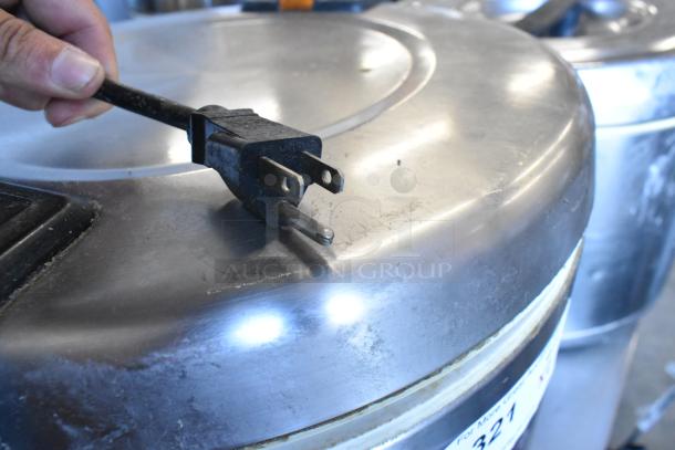 Two metal rice warmers, 120 volts, 1 phase, shown with power plug and visible wear; auction item offers two for one bid.