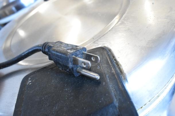 Two metal rice warmers, 120 volts, 1 phase, shown with a close-up of a power plug. Good condition.