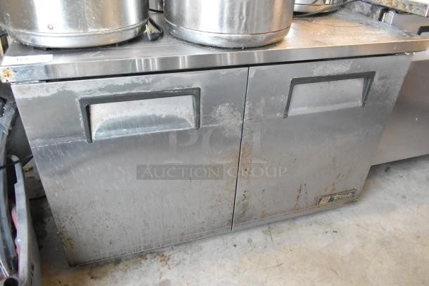 True TUC-48-LP stainless steel 2-door undercounter cooler, visible wear, model and brand labels. 115V, 1 phase.