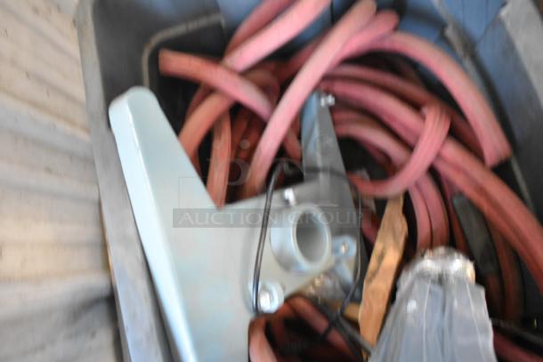 Poly bin with various items, including coiled red hose and metal bracket, condition mixed; potential for diverse use.